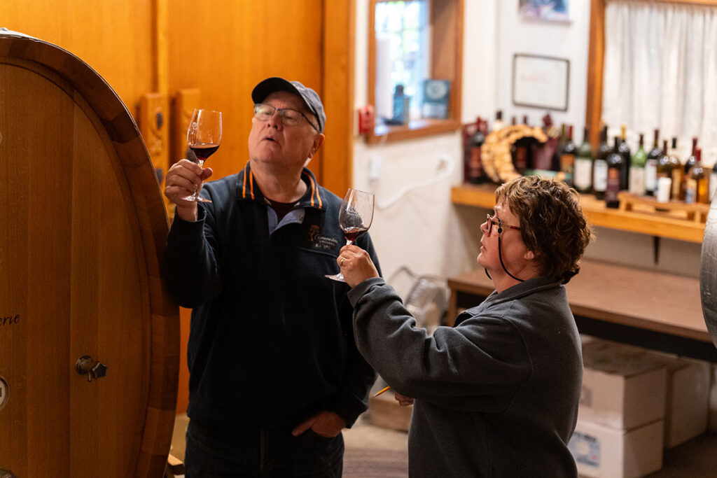 Amy and Don inspecting wine